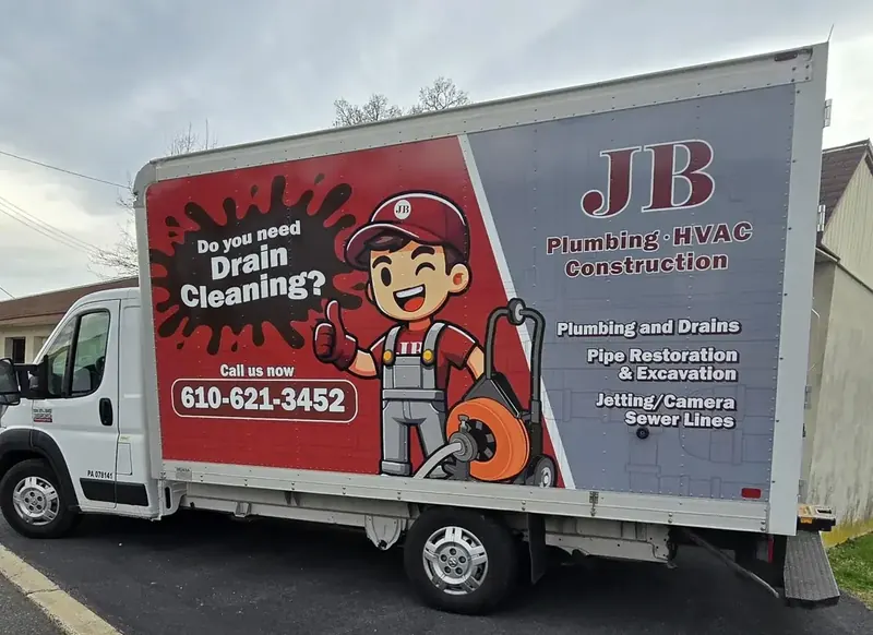 JB Plumbing HVAC drain cleaning truck with phone number and branding