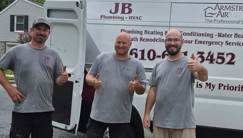Three JB Plumbing HVAC technicians giving a thumbs up in front of a branded company van